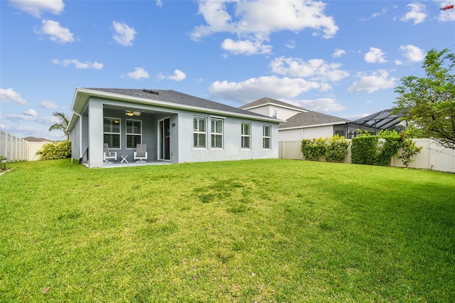 751 Cajeput Loop, Tarpon Springs, FL 34689 - rear view of house with stucco siding, a patio area, and ceiling fan