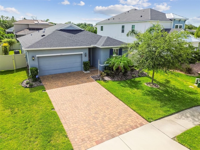 751 Cajeput Loop, Tarpon Springs, FL 34689 - single story home featuring a garage, roof with shingles, decorative driveway, and stucco siding