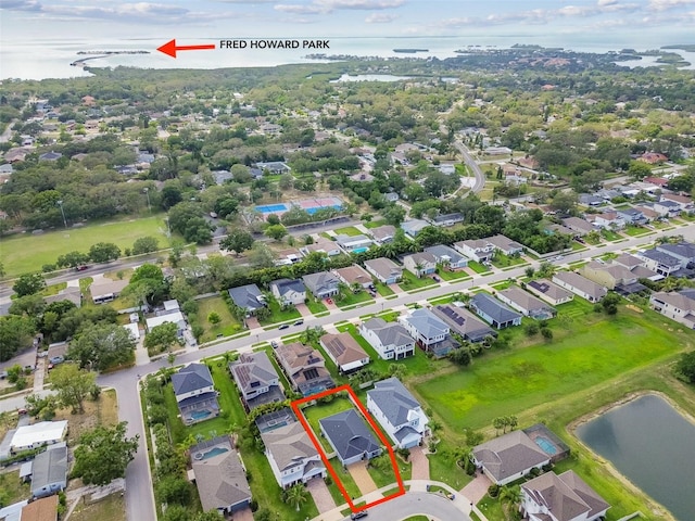 751 Cajeput Loop, Tarpon Springs, FL 34689 - aerial perspective of suburban area with property parcel outlined and a large body of water