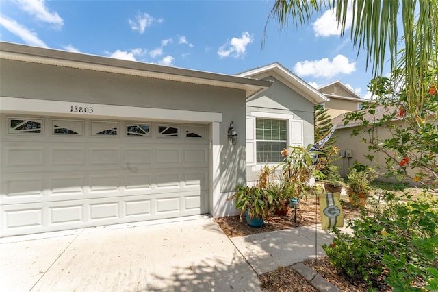 13803 Chalk Hill Pl, Riverview, FL 33579 - view of side of home featuring concrete driveway, an attached garage, and stucco siding