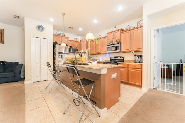 13803 Chalk Hill Pl, Riverview, FL 33579 - kitchen with appliances with stainless steel finishes, a kitchen island with sink, light tile patterned floors, a breakfast bar, and recessed lighting
