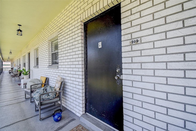 4050 4th St N Unit 205, Saint Petersburg, FL 33703 - view of exterior entry with covered porch and brick siding
