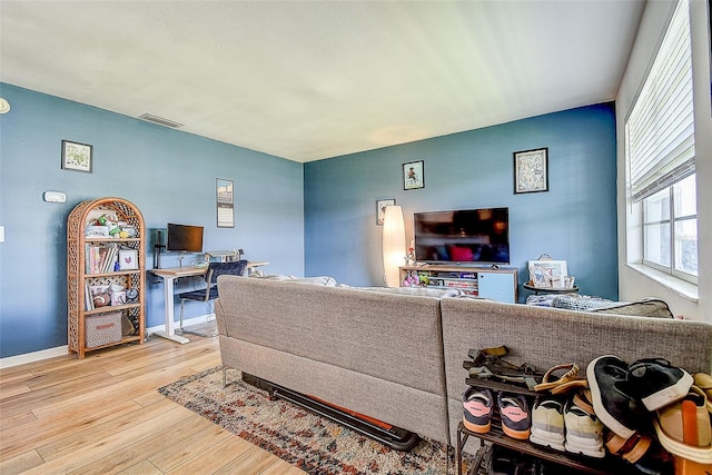 4050 4th St N Unit 205, Saint Petersburg, FL 33703 - living room with light wood-style floors and baseboards