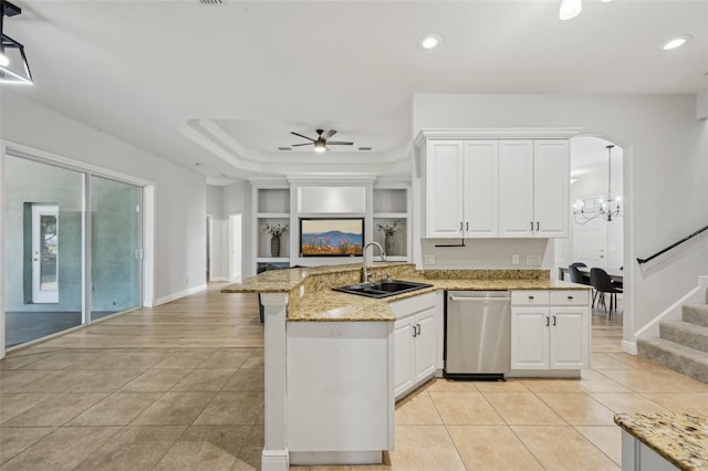 707 9th Ave SW, Ruskin, FL 33570 - kitchen with stainless steel dishwasher, a sink, a peninsula, light tile patterned floors, and light stone counters
