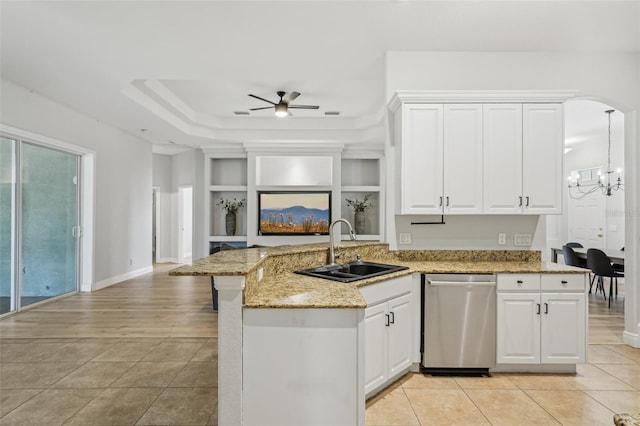 707 9th Ave SW, Ruskin, FL 33570 - kitchen featuring dishwasher, a sink, light tile patterned floors, a peninsula, and white cabinetry