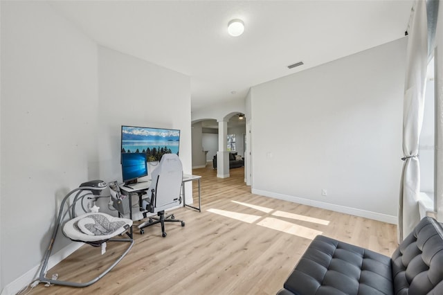 707 9th Ave SW, Ruskin, FL 33570 - home office featuring arched walkways, wood finished floors, and baseboards