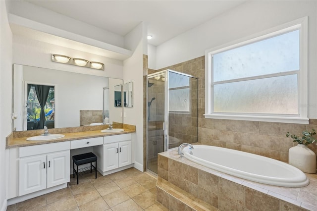 707 9th Ave SW, Ruskin, FL 33570 - bathroom featuring a bath, double vanity, a stall shower, and tile patterned flooring
