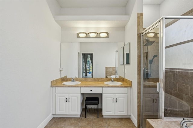 707 9th Ave SW, Ruskin, FL 33570 - bathroom featuring double vanity, a shower stall, tile patterned flooring, and baseboards