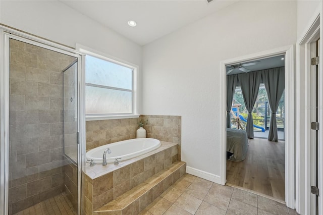 707 9th Ave SW, Ruskin, FL 33570 - ensuite bathroom featuring a garden tub, a stall shower, tile patterned flooring, baseboards, and ceiling fan