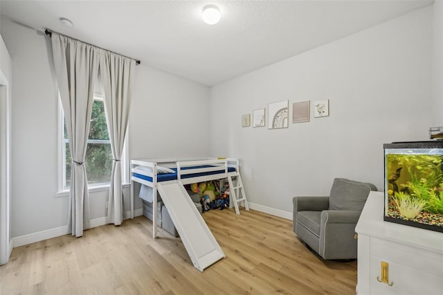 707 9th Ave SW, Ruskin, FL 33570 - bedroom with light wood-style floors and baseboards