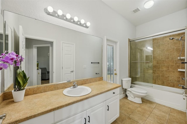 707 9th Ave SW, Ruskin, FL 33570 - full bath featuring vanity, toilet, enclosed tub / shower combo, and tile patterned flooring