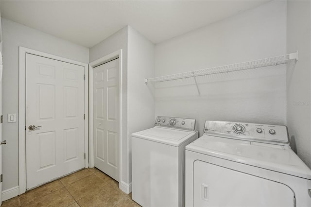 707 9th Ave SW, Ruskin, FL 33570 - laundry room with washer and dryer and light tile patterned floors