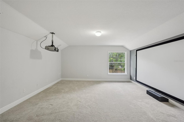 707 9th Ave SW, Ruskin, FL 33570 - home theater room featuring vaulted ceiling, baseboards, and light carpet