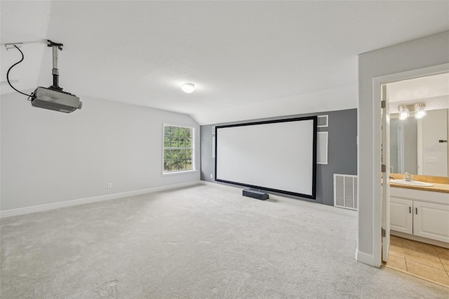 707 9th Ave SW, Ruskin, FL 33570 - home theater with lofted ceiling, a sink, light carpet, and baseboards