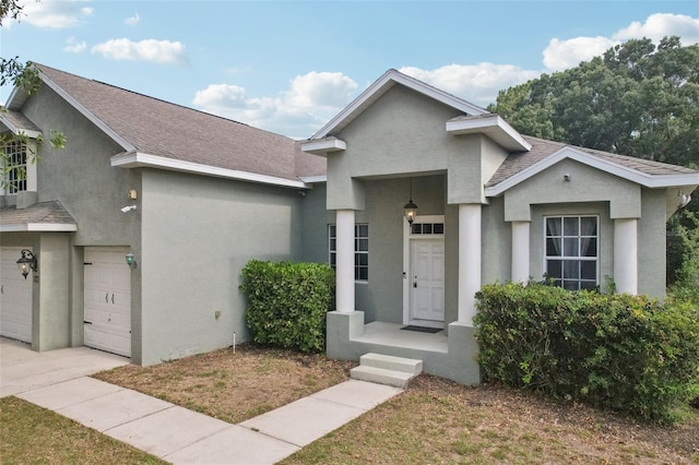 707 9th Ave SW, Ruskin, FL 33570 - view of front of house featuring stucco siding, roof with shingles, and an attached garage