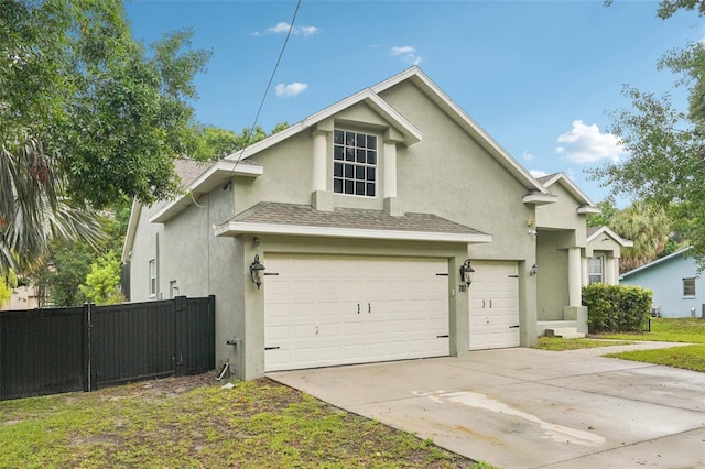 707 9th Ave SW, Ruskin, FL 33570 - traditional-style house with stucco siding, a garage, concrete driveway, and a shingled roof