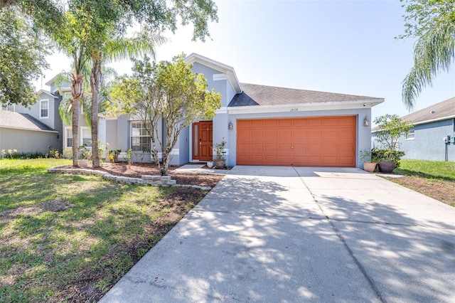 12136 Luftburrow Ln, Hudson, FL 34669 - view of front facade with stucco siding, an attached garage, driveway, and a front yard