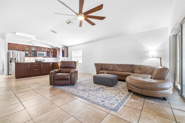 12136 Luftburrow Ln, Hudson, FL 34669 - living room featuring lofted ceiling, a ceiling fan, and light tile patterned flooring