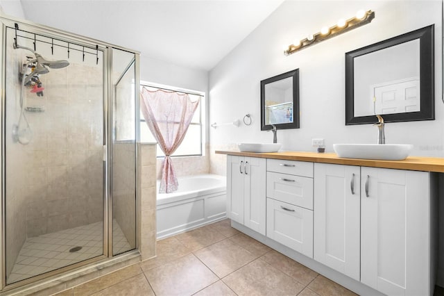 12136 Luftburrow Ln, Hudson, FL 34669 - full bath with double vanity, a stall shower, a garden tub, tile patterned floors, and lofted ceiling
