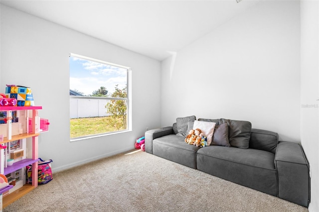 12136 Luftburrow Ln, Hudson, FL 34669 - carpeted living area featuring baseboards and vaulted ceiling