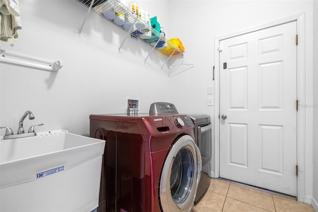 12136 Luftburrow Ln, Hudson, FL 34669 - laundry room featuring separate washer and dryer and light tile patterned flooring