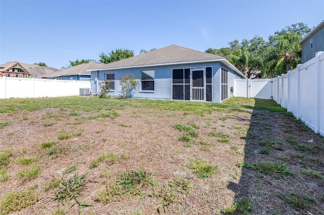 12136 Luftburrow Ln, Hudson, FL 34669 - rear view of house featuring a fenced backyard, a gate, a sunroom, central AC unit, and stucco siding