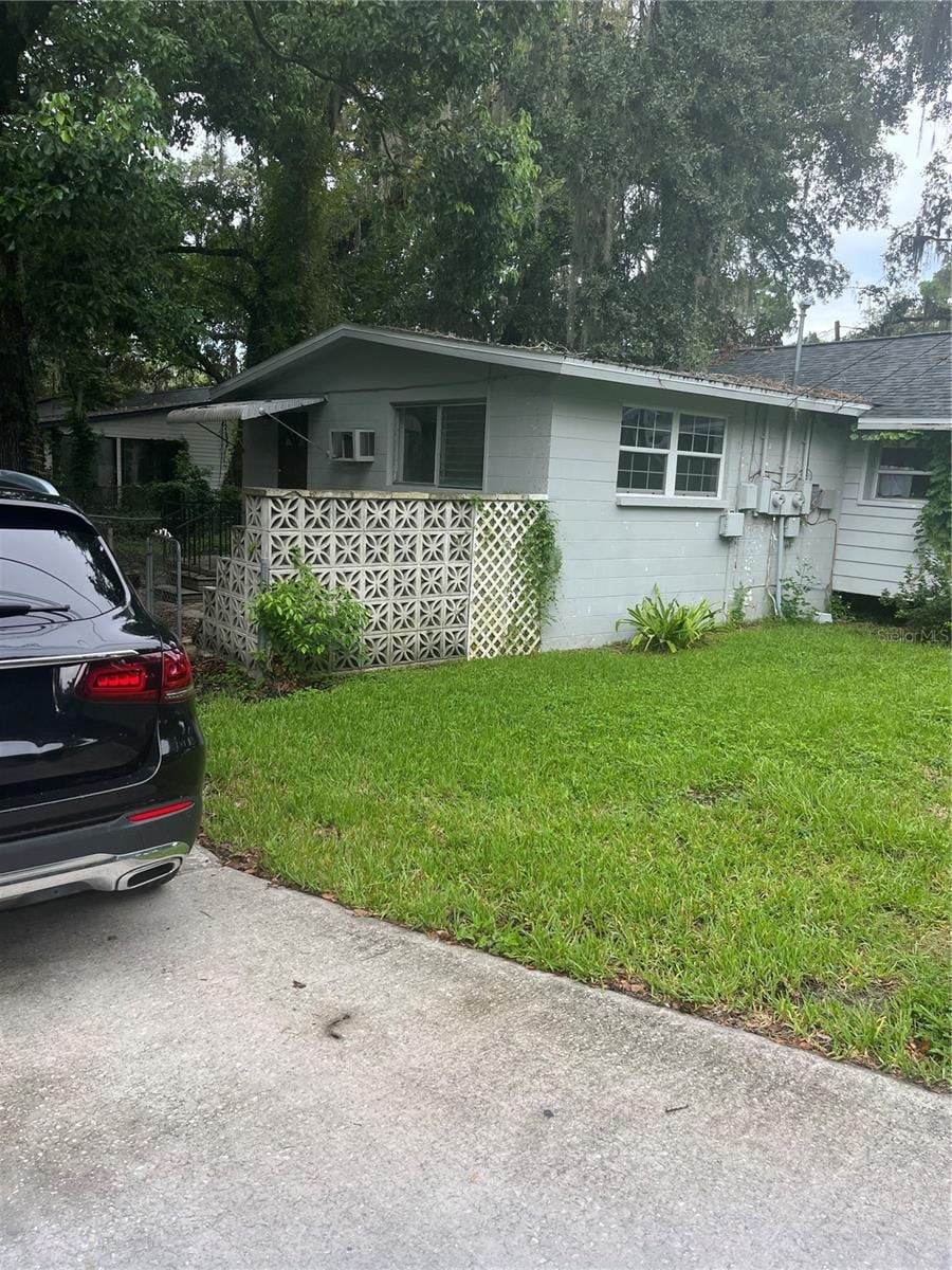 5714 Kenwood Ave, New Port Richey, FL 34652 - view of front of house featuring a front lawn