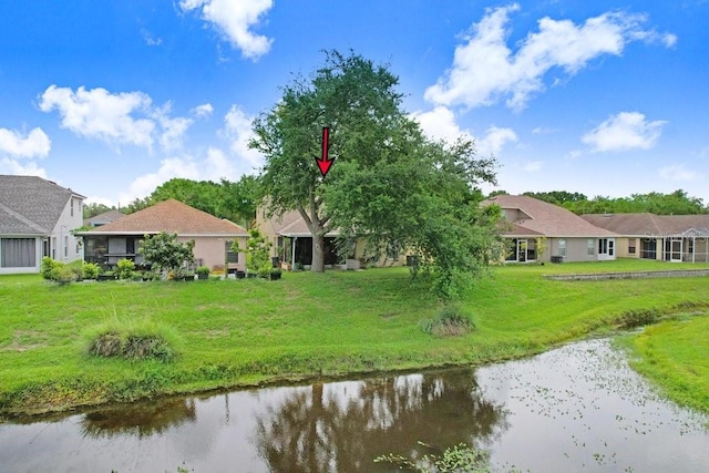 5525 Turtle Crossing Loop, Tampa, FL 33625 - back of property featuring a water view, a lawn, and a residential view