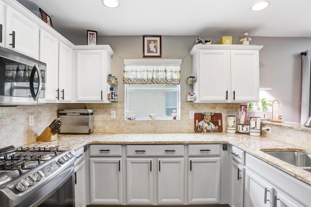 5525 Turtle Crossing Loop, Tampa, FL 33625 - kitchen featuring appliances with stainless steel finishes, tasteful backsplash, white cabinetry, and recessed lighting