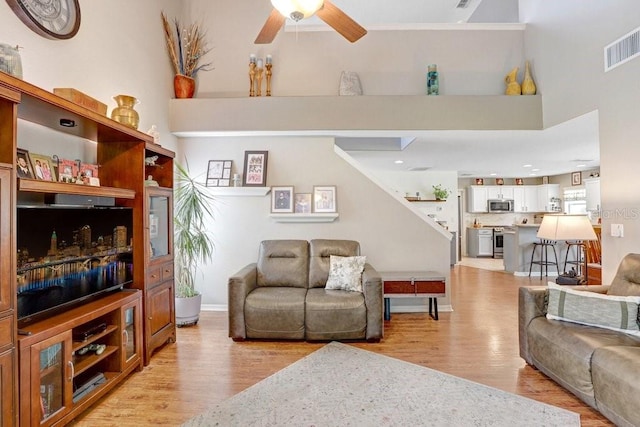 5525 Turtle Crossing Loop, Tampa, FL 33625 - living room featuring light wood-type flooring, a ceiling fan, and baseboards