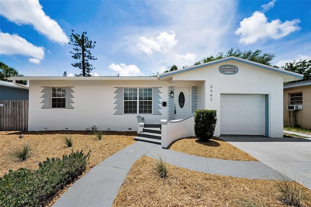 5642 9th Ave N, Saint Petersburg, FL 33710 - ranch-style house featuring a garage, stucco siding, driveway, and cooling unit