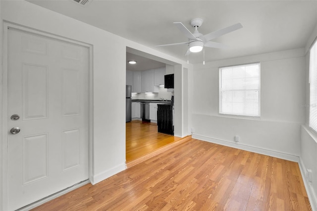 5642 9th Ave N, Saint Petersburg, FL 33710 - unfurnished room featuring a ceiling fan, light wood-style floors, plenty of natural light, and baseboards