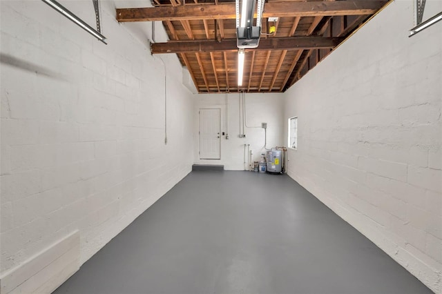 5642 9th Ave N, Saint Petersburg, FL 33710 - garage featuring water heater, a garage door opener, and concrete block wall