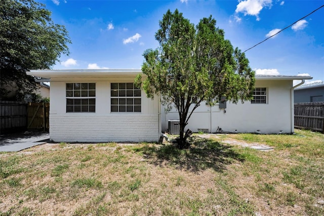 5642 9th Ave N, Saint Petersburg, FL 33710 - rear view of property featuring cooling unit, brick siding, and stucco siding