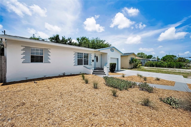 5642 9th Ave N, Saint Petersburg, FL 33710 - ranch-style home with a garage, stucco siding, and driveway