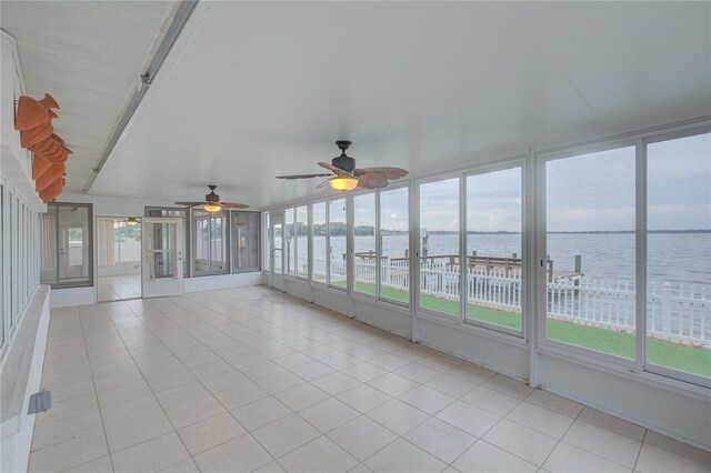 31 Freshwater Dr, Palm Harbor, FL 34684 - unfurnished sunroom with a water view, tile patterned floors, and ceiling fan