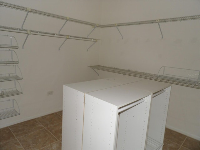 31 Freshwater Dr, Palm Harbor, FL 34684 - walk in closet with dark tile patterned floors