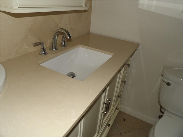 31 Freshwater Dr, Palm Harbor, FL 34684 - half bathroom with toilet, vanity, tasteful backsplash, and tile patterned flooring