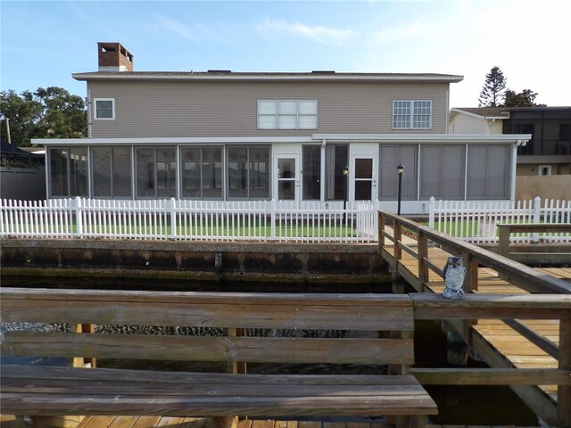 31 Freshwater Dr, Palm Harbor, FL 34684 - rear view of house featuring a sunroom and a chimney