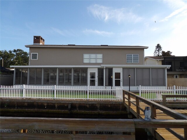 31 Freshwater Dr, Palm Harbor, FL 34684 - rear view of house featuring a sunroom and a chimney