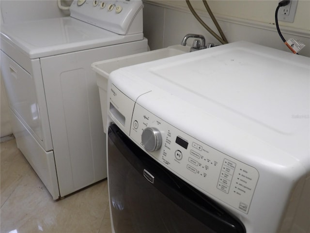 31 Freshwater Dr, Palm Harbor, FL 34684 - laundry room featuring washer and clothes dryer and light tile patterned floors