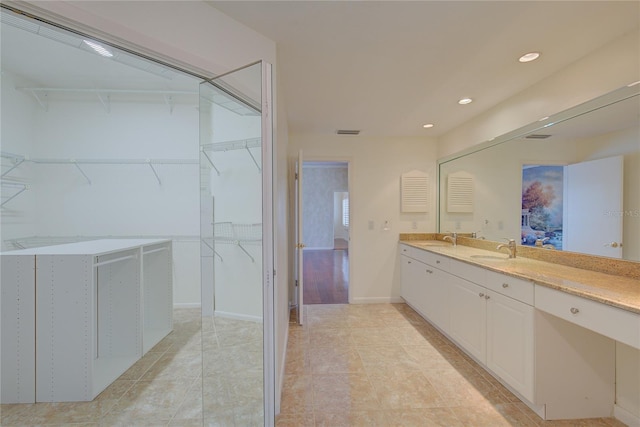 31 Freshwater Dr, Palm Harbor, FL 34684 - bathroom with double vanity, recessed lighting, baseboards, tile patterned flooring, and a walk in closet