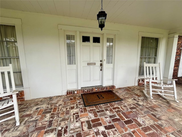 1002 W Pinedale Dr, Plant City, FL 33563 - doorway to property with a porch and stucco siding