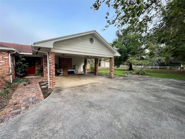 1002 W Pinedale Dr, Plant City, FL 33563 - view of home's exterior with driveway, brick siding, and a carport