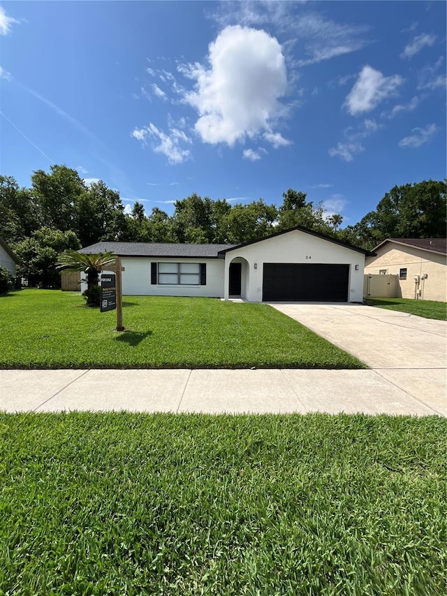 34 Aaron Cir, Ormond Beach, FL 32174 - ranch-style house with an attached garage, a front yard, driveway, and stucco siding