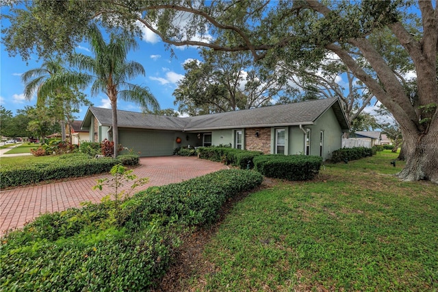 9611 107th Ave N, Largo, FL 33773 - ranch-style home with an attached garage, stucco siding, decorative driveway, and a front yard