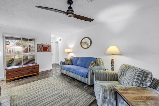 9611 107th Ave N, Largo, FL 33773 - living room featuring a ceiling fan, wood finished floors, a textured ceiling, baseboards, and crown molding