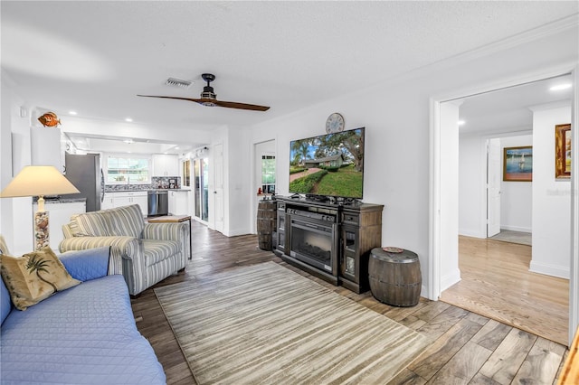 9611 107th Ave N, Largo, FL 33773 - living area featuring ceiling fan, wood finished floors, plenty of natural light, baseboards, and recessed lighting