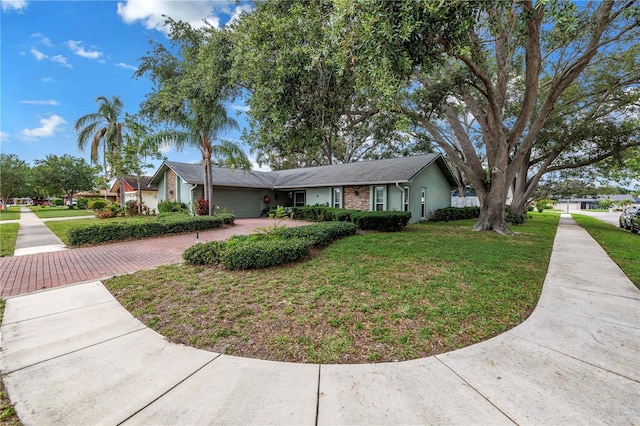 9611 107th Ave N, Largo, FL 33773 - view of front of house featuring driveway, an attached garage, and a front yard