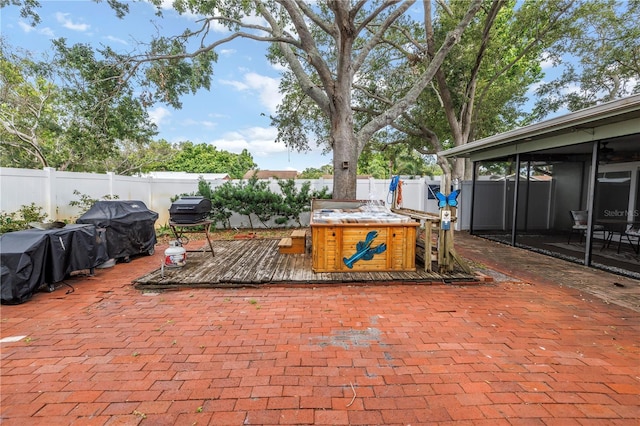 9611 107th Ave N, Largo, FL 33773 - fenced backyard with a deck, area for grilling, and a sunroom